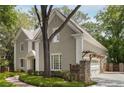 View of home's exterior with detailed trim, attached garage, and brick-lined walkway at 2375 Hyde Park Nw Ct, Atlanta, GA 30318