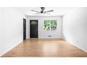 Bright living room with hardwood floors and a large window providing natural light at 264 Howell Sw Ter, Atlanta, GA 30331