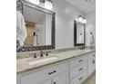 Elegant bathroom featuring double sinks, granite countertops, and large mirrors at 2095 Honeysuckle Dr, Cumming, GA 30040