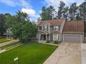 Beautiful two-story home with a well-maintained lawn, mature trees, and an attached two-car garage at 4903 Wilkie Nw Way, Acworth, GA 30102