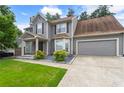 Attractive two-story home with gray siding, lush lawn, mature landscaping, and an attached garage at 4903 Wilkie Nw Way, Acworth, GA 30102