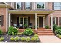 Charming front porch features decorative seating and a brick walkway at 217 Heritage Town Pkwy, Canton, GA 30115