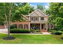 Beautiful two-story home with manicured lawn and inviting front porch at 217 Heritage Town Pkwy, Canton, GA 30115