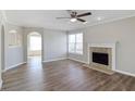 Bright living room featuring hardwood floors, a decorative fireplace, ceiling fan and neutral paint at 341 Windermere Dr., Loganville, GA 30052