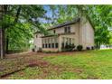 View of the home's backyard with large trees and a fenced perimeter at 133 Sw Patterson Rd, Lawrenceville, GA 30044