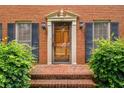 Close-up of front door with brick facade and updated fixtures at 133 Sw Patterson Rd, Lawrenceville, GA 30044