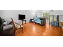 Spacious living room with hardwood floors and a large window, perfect for relaxing or entertaining guests at 1991 Flat Shoals Rd, Riverdale, GA 30296