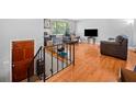 View of the living room and stairs to the lower level featuring hardwood floors and neutral paint at 1991 Flat Shoals Rd, Riverdale, GA 30296