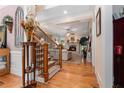 Elegant foyer with hardwood floors, staircase, and an open view to the living room with a fireplace at 3698 Lakeview Drive, Tucker, GA 30084