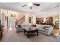 Spacious living room featuring hardwood floors, coffered ceilings, fireplace, and an open layout to the kitchen at 3698 Lakeview Drive, Tucker, GA 30084
