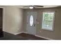Home entryway with a decorative glass front door and a window that lets in natural light at 6197 Union Grove Rd, Lithia Springs, GA 30122