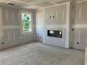 Spacious living room featuring a sleek, modern fireplace and ample natural light at 7226 Lacey Dr Lot 125, Douglasville, GA 30134