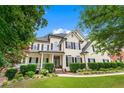 Stately two-story home features manicured lawn and mature trees at 5833 Wembley Dr, Douglasville, GA 30135