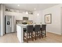 Modern kitchen with stainless steel appliances, a center island with bar stools, and pendant lighting at 8501 Polston Place Lot 143, Douglasville, GA 30134