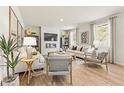 Cozy living room with ample seating, fireplace, hardwood floors, and abundant natural light from large windows at 8504 Polston Place Lot 145, Douglasville, GA 30134