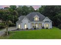 Charming, single-story home with a manicured lawn and white painted brick at 2330 Wood Creek Ct, Dacula, GA 30019