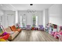 Bright living room featuring hardwood floors, large windows, and stylish decor at 2330 Wood Creek Ct, Dacula, GA 30019