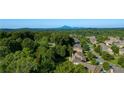 Gorgeous aerial view of neighborhood with mature trees and mountain in the distance at 3978 Devonshire Dr, Marietta, GA 30066