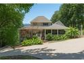 Charming exterior with screened porch, mature landscaping, and concrete driveway at 3978 Devonshire Dr, Marietta, GA 30066