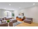 Spacious living room with hardwood floors, neutral decor, and a large window at 200 Renaissance Ne Pkwy # 219, Atlanta, GA 30308
