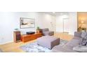 Open-concept living room with hardwood floors, and ample seating at 200 Renaissance Ne Pkwy # 219, Atlanta, GA 30308