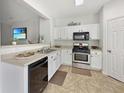 Functional kitchen features white cabinets, stainless steel appliances, and practical layout at 2964 Greyhawk Ln # 160, Cumming, GA 30040