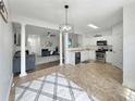 Open-concept kitchen and living area filled with natural light and stylish decor at 2964 Greyhawk Ln # 160, Cumming, GA 30040
