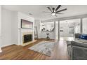 Inviting living room featuring a fireplace, ceiling fan, and open floor plan at 2964 Greyhawk Ln, Cumming, GA 30040