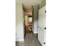 View of the entryway, with gray and brown floors, from the open front door into the dining area at 3233 Rockmill Dr, Ellenwood, GA 30294