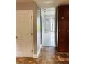 View of the hallway with tile and wood flooring, a utility closet, and front entrance at 3233 Rockmill Dr, Ellenwood, GA 30294