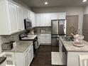 Bright kitchen featuring white cabinets, granite countertops, and stainless steel appliances at 370 Winston Cir, Canton, GA 30114