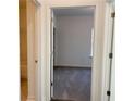 View of bedroom with neutral carpet, leading to a full ensuite bathroom at 3865 Shelleydale Dr # 82, Powder Springs, GA 30127