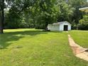 Expansive backyard with lush greenery and detached garage or shed at 3561 Clay Rd, Austell, GA 30106
