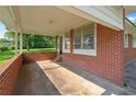 Covered patio with brick siding, ideal for outdoor relaxation and entertaining at 3561 Clay Rd, Austell, GA 30106