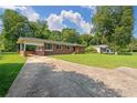 Quaint brick home with a well-maintained lawn and a long driveway, providing ample parking space at 3561 Clay Rd, Austell, GA 30106