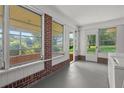 Bright sun room featuring brick accents and large windows offering serene views of the surrounding greenery at 3561 Clay Rd, Austell, GA 30106