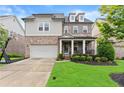 Charming two-story home features a mix of brick and siding, a welcoming front porch, and a well-manicured lawn at 4130 Millbrook Ct, Suwanee, GA 30024