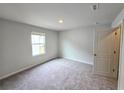 Bright carpeted bedroom with natural light from a window and a neutral color palette at 2674 Mourning Dove Drive (Lot 37), Grayson, GA 30017