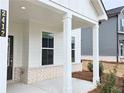 Close up view of the front porch showing white columns, brick trim and the house number at 2674 Mourning Dove Drive (Lot 37), Grayson, GA 30017