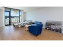 Open concept living space featuring hardwood floors, modern décor, large windows and unobstructed city views at 788 W Marietta Nw St # 212, Atlanta, GA 30318