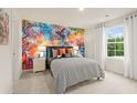 Vibrant bedroom featuring a colorful mural wall, window, and stylish furnishings at 8503 Polston Place Lot 142, Douglasville, GA 30134