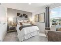 Comfortable main bedroom with a decorative headboard, accent wall, and natural light at 8503 Polston Place Lot 142, Douglasville, GA 30134