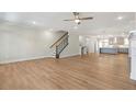 Open floor plan showcasing hardwood floors and seamless transition to the kitchen at 148 Palm St, Holly Springs, GA 30115