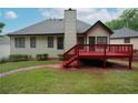 Back exterior view showcasing a spacious backyard, red deck, and traditional siding at 655 Golden Meadows Ln, Suwanee, GA 30024