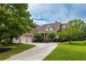 Beautiful home featuring a three-car garage, pristine landscaping, and a long driveway leading to the residence at 2403 Wistful Way, Marietta, GA 30066