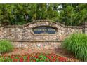 Brookview Manor entrance sign featuring beautiful stonework and vibrant red flowers at 2403 Wistful Way, Marietta, GA 30066