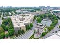 A picturesque apartment complex with manicured lawns, a pond, and scenic views of the surrounding neighborhood and city at 390 17Th Nw St # 2053, Atlanta, GA 30363
