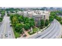 A beautiful view of the apartment complex exterior surrounded by verdant trees, green space, and an adjacent road at 390 17Th Nw St # 2053, Atlanta, GA 30363