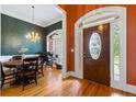 Elegant entryway featuring hardwood floors, decorative front door, and views into the dining and office areas at 40 Costleys Bridge Dr, Oxford, GA 30054