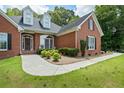 Well-manicured lawn leads to a brick home with decorative windows and an inviting walkway, perfect for curb appeal at 40 Costleys Bridge Dr, Oxford, GA 30054